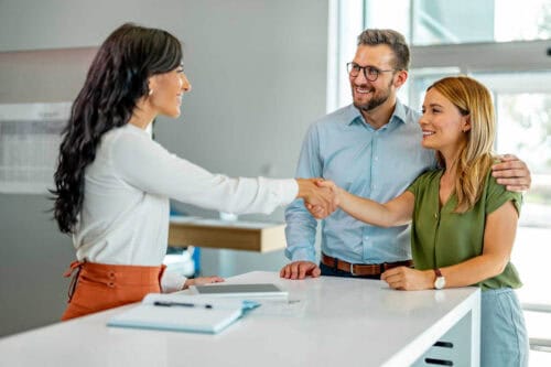 real estate agent in CA showing home to clients