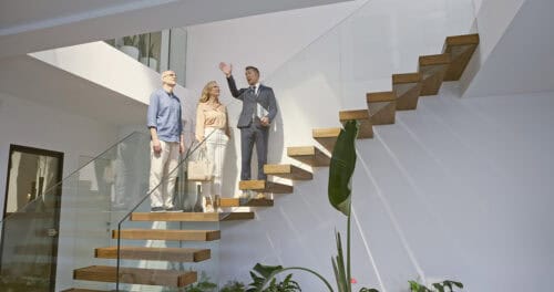 gent showing luxury home to clients