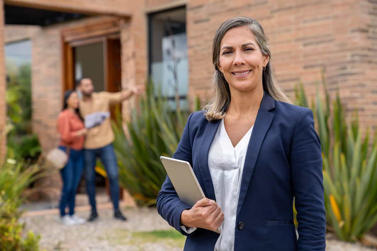 smiling female real estate agent showing home